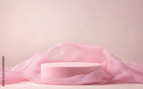 A pale pink pedestal sits in front of tulle drapery, with studio light casting soft shadows. Ideal for soft beauty product shoots.
