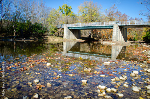 Shallow waters under a bridge in the woods