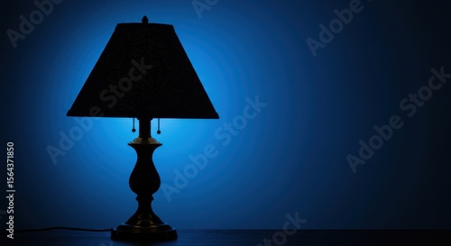 Elegant lamp casting a soft blue glow in a dimly lit room, creating a serene atmosphere