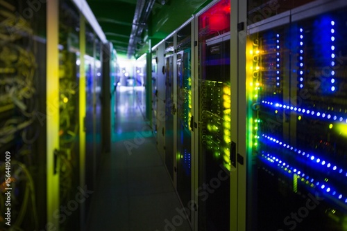 Foto Server rack on right side is showing blinking LED panels in flat design corridor