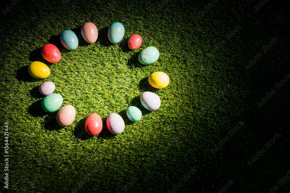 Naklejka premium Colorful Easter eggs in circle on grass at garden