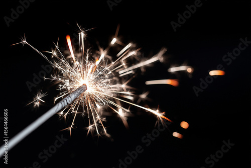 Wallpaper Mural Single sparkler burning against plain dark backdrop, Independence Day atmosphere,  Torontodigital.ca