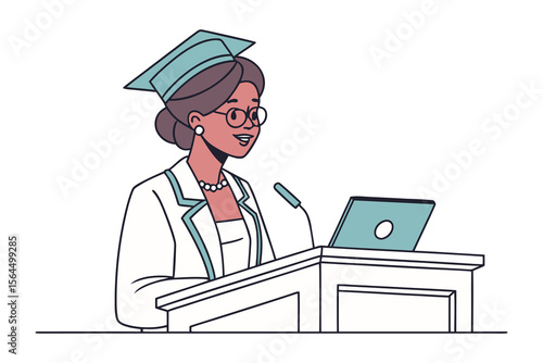 A woman in a graduation cap and gown delivers a speech at a podium with a microphone and laptop