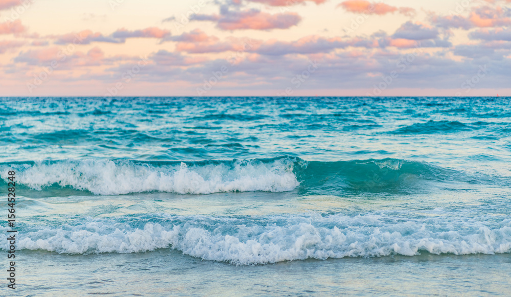 Obraz premium Dramatic sunrise horizon at sea. Romantic summer vacation on sunset seascape. Sea sunset on ocean. Sunset seascape at summer vacation. Sunrise with sea beach