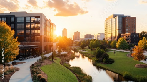 Modern urban park landscape with river and city buildings at sunset with colorful sky and trees