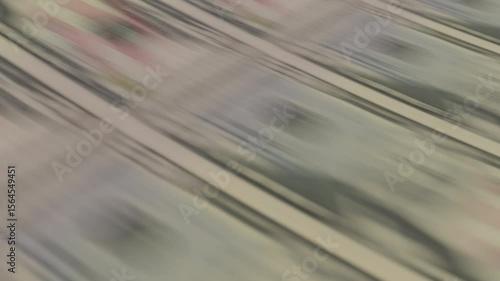 Close-up of fifty dollar bills being printed on a press. Perfect for themes of money creation, financial systems, economy, inflation, and monetary policy. Looped video