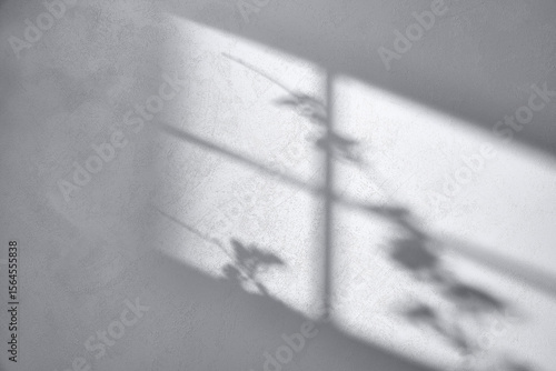 Fotografie Concrete texture background with shadows from natural light streaming through a window