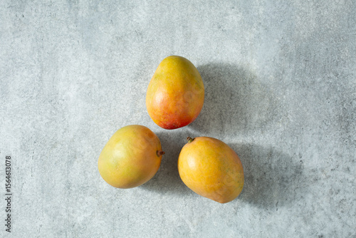 Vászonkép A top down view of three Tommy Atkins mangos.