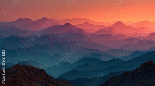 A beautiful landscape view of multiple mountain ranges at sunset with a colorful sky above them all