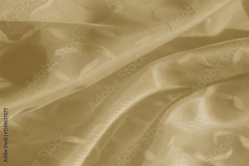 Smooth, elegant golden silk fabric with a flowing, shiny texture creates a luxurious backdrop