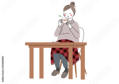 温かいお茶とひざ掛けで体を温めている妊婦さん