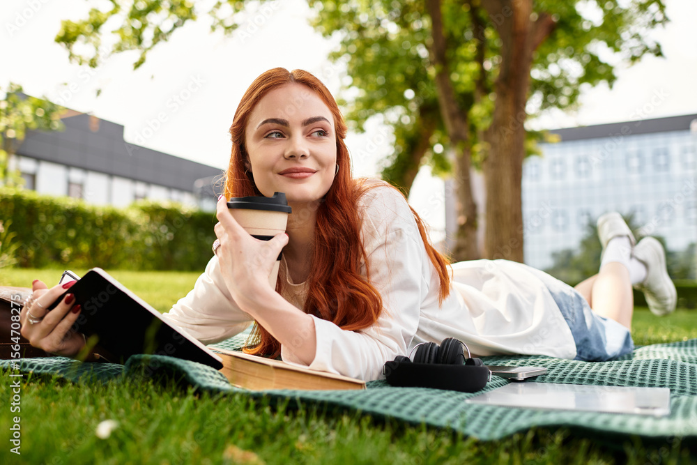 © Bliss - Relaxing in the park with a notebook and coffee during a sunny afternoon retreat