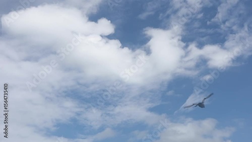 Time lapse ,slow motion fluffy of groups white clouds moving on blue sky background,in rainy season