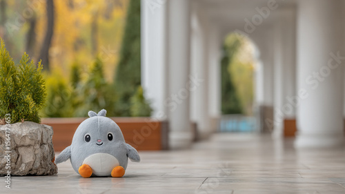 Adorable Gray Plush Bird Toy in Serene Outdoor Setting