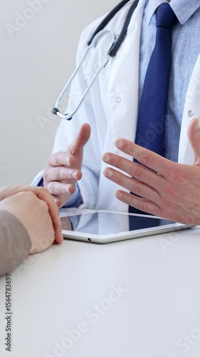 Doctor gesturing with hands while explaining diagnosis to patient during medical consultation in hospital office, healthcare and medical concept. Medicine