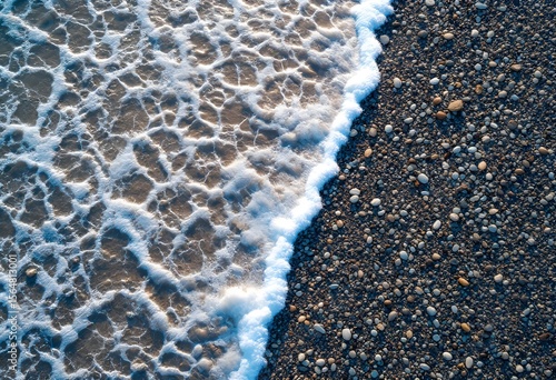 Wallpaper Mural Aerial View of Foamy Waves Crashing on Pebble Beach Sunlight Reflecting. Torontodigital.ca