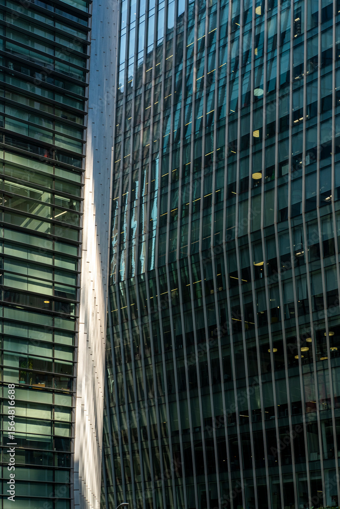 Glass facades and architectural surfaces in financial district architecture display modern design, geometric textures, reflections and urban minimalism emphasizing architectural details and clarity. Glass facades and architectural surfaces in financial district architecture display modern design, geometric textures, reflections and urban minimalism emphasizing architectural details and clarity.