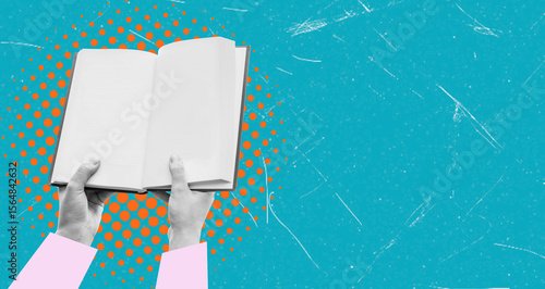 Open book in hand on a blue background with copy space.