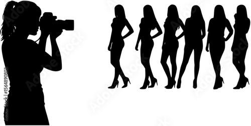 Female photographer with camera taking photos of group sexy female models standing in a row black silhouettes.
