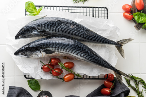 fresh mackerel fish carcass on a bright table. preparation for cooking dinner. fish in the oven on the grill. raw, unpeeled fish