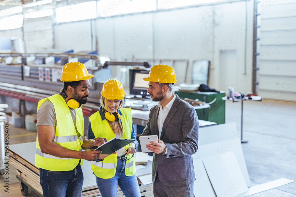 Team of Engineers Discussing Project in Industrial Manufacturing Setting Team of Engineers Discussing Project in Industrial Manufacturing Setting