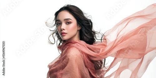 Elegant woman with flowing pink scarf. Beautiful, soft lighting. Ideal for beauty, fashion, and cosmetics.