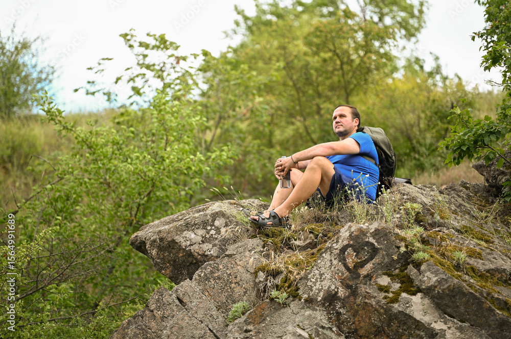 man in sports suit with backpack doing active sports on mountain man in sports suit with backpack doing active sports on mountain