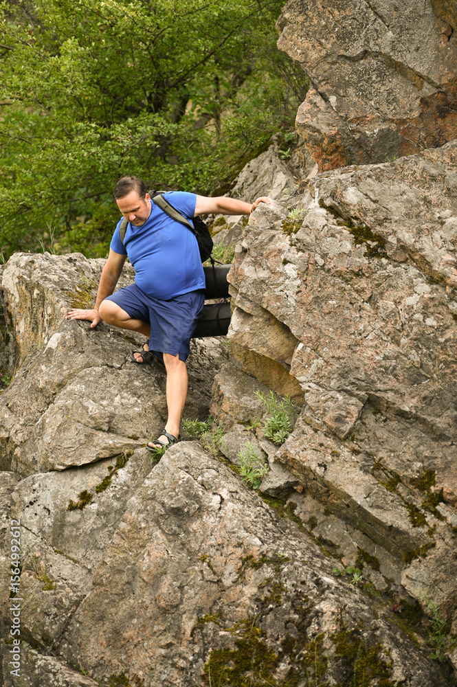 man in sports suit with backpack doing active sports on mountain man in sports suit with backpack doing active sports on mountain