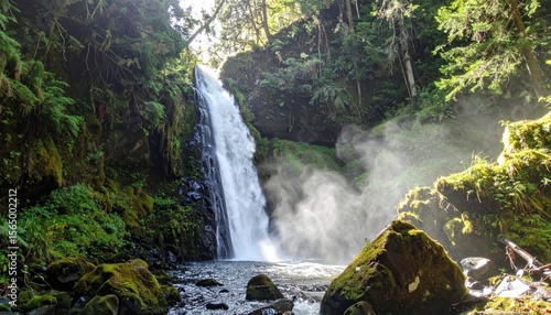 Waterfall cascading into a pool amid lush green forest with sunlit mist