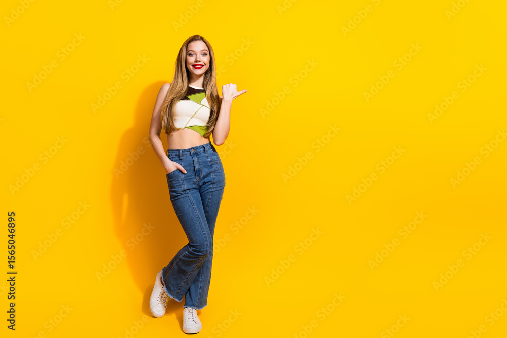 Smiling young woman in casual outfit posing against vivid yellow background with a confident and cheerful expression Smiling young woman in casual outfit posing against vivid yellow background with a confident and cheerful expression