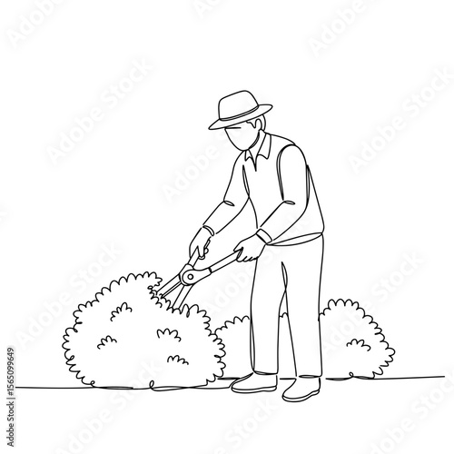 Man pruning bushes in garden wearing hat and casual clothing  
