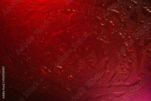 Wet glass. Drops of water on glass. Abstract red texture. Light spots