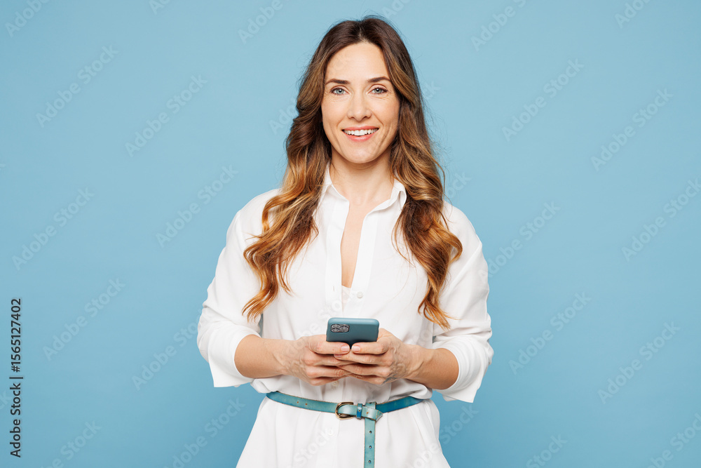 © ViDi Studio - Young smiling employee business woman corporate lawyer she wear shirt classic formal clothes work in office hold in hand use mobile cell phone isolated on pastel light blue background studio portrait. © ViDi Studio - Young smiling employee business woman corporate lawyer she wear shirt classic formal clothes work in office hold in hand use mobile cell phone isolated on pastel light blue background studio portrait.