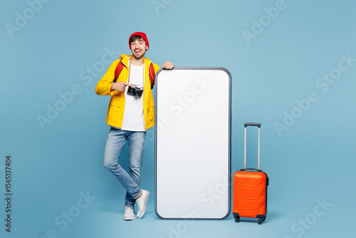 Billede på lærred Traveler man wear yellow casual clothes point big huge blank screen mobile cell