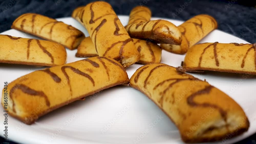 Fresh chocolate covered cookies on a plate,woman holding a cookie,pastry,home cooking.