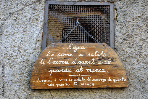 wooden sign with Genoese proverb: (translation) water is like health, you realize how much it is worth when you lack it voltaggio alessandria italy