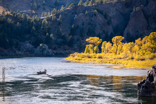 Fishermen rowing boat on Missouri River in autumn, Montana