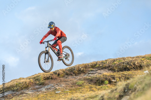 Man biking downhill in the scenic Alps landscape