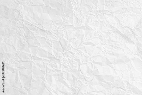 Abstract background of a white crumpled paper sheet. Blank wrinkled surface for a design and texture overlay.