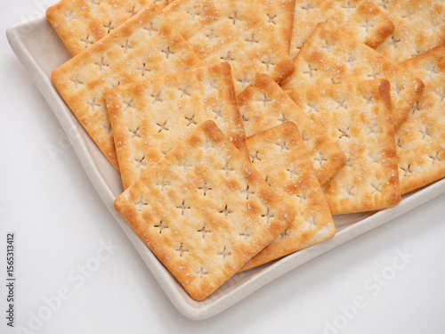 Square Salted Crackers on White Ceramic Plate