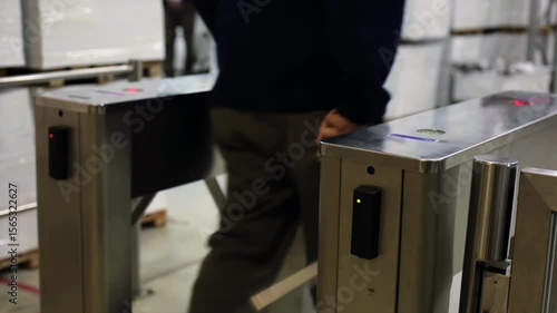 Employee Using Badge for Entry at Industrial Facility Turnstile - Low Angle View - 4K