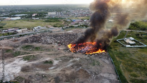 Landfill Fire with Heavy Smoke and Firefighting Equipment – Aerial View