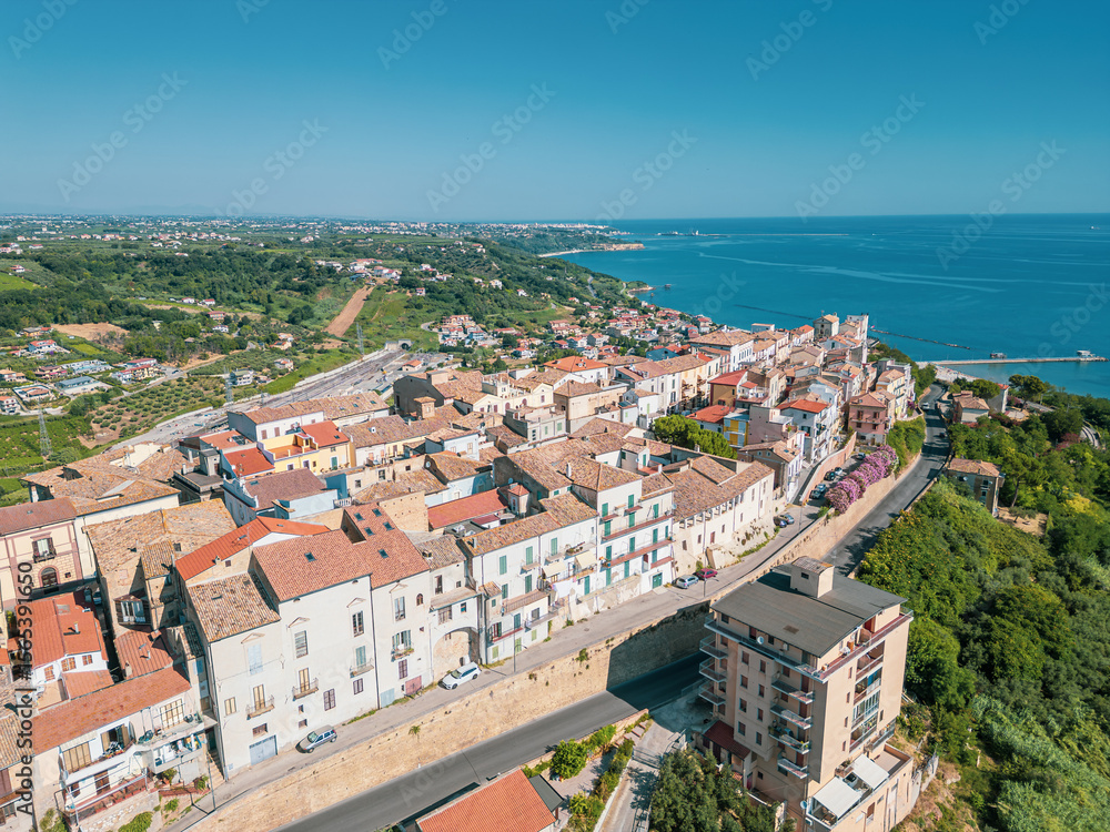 Obraz premium Italy, July 03, 2025: Aerial drone view of San Vito Chietino, a seaside resort on the Trabocchi coast. Here the sea is crystal clear and the area is very relaxing and full of tourists