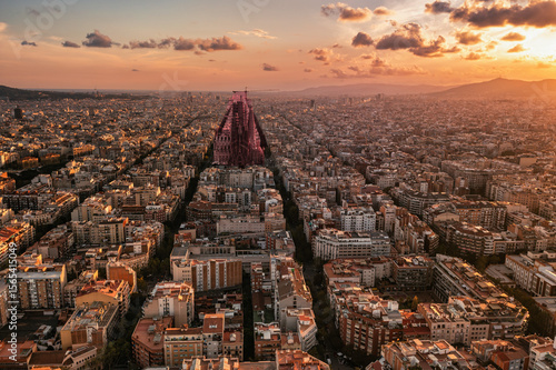  Barcelona Eixample District: Dense Urban Grid with Sagrada Familia.

An aerial view showcasing Barcelona's iconic Eixample grid, dense residential blocks, and the Sagrada Familia towering 