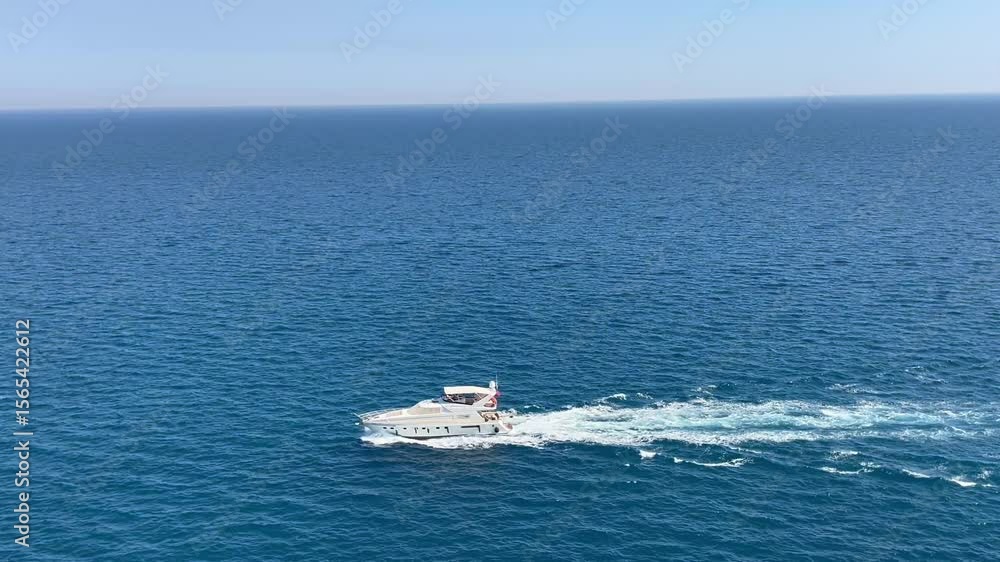 Yacht traveling in blue sea under blue sky Yacht traveling in blue sea under blue sky