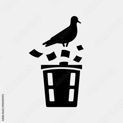 One-legged pigeon standing on overflowing trash bin