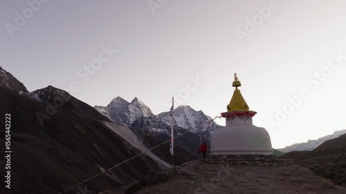Drone Footage of a White Stupa with Yellow Top in the Himalayas of Nepal, Capturing the Serenity of Early Morning Light and Snow-Capped Mountains