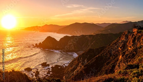 Coastal cliffs overlooking the ocean at sunset with mountains in background