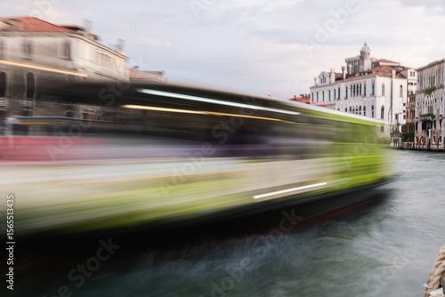 Blurred water taxi on Venice canal captures speed and motion