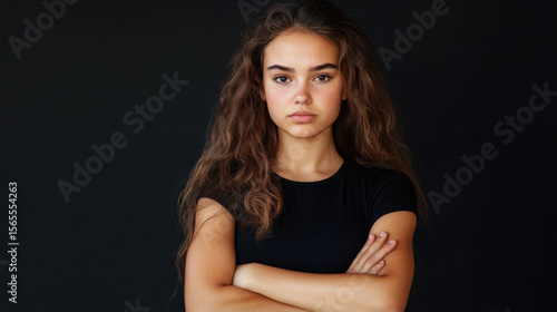 Wallpaper Mural Young woman with a stern expression crossing her arms in an X shape.  Torontodigital.ca